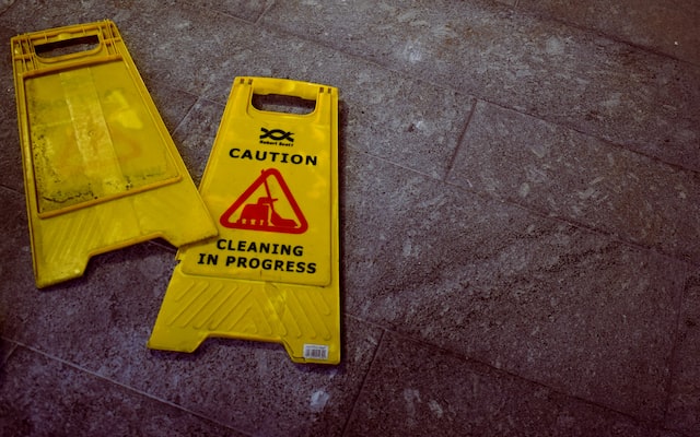 yellow sign warning people of wet floors